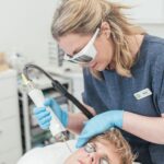 Dr Tanja Phillips applied a Fotona laser device to a patient’s cheek, targeting rosacea redness.