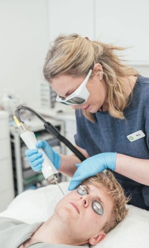 Dr Tanja Phillips applied a Fotona laser device to a patient’s cheek, targeting rosacea redness.