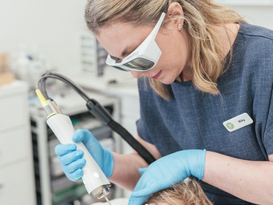 Dr Tanja Phillips applied a Fotona laser device to a patient’s cheek, targeting rosacea redness.